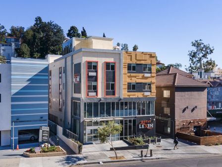 The image shows a modern hotel building named 