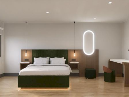 The image shows a modern bedroom with a double bed, pendant lights, a sleek desk, a chair, and large window.